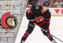 Picture of Ottawa Senators defenseman Erik Brannstrom shooting a puck.