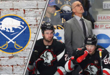 Buffalo Sabres coach Don Granato contemplating during a challenging game, reflecting team’s performance issues.