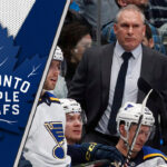 The Perfect Fit: Craig Berube and the Toronto Maple Leafs Craig Berube strategizing during an NHL game, showcasing his intense coaching style and dedication to hockey excellence.