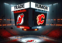 Noah Hanifin in Flames gear discussing strategy, hinting at potential trade to New Jersey Devils