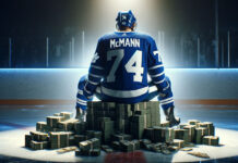 Bobby mcMann sitting on a pile of money after signing a new contract extension
