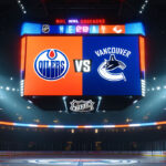 How to Watch Edmonton Oilers vs. Vancouver Canucks: Game 2 Guide Vancouver Canucks and Edmonton Oilers logos on an NHL scoreboard