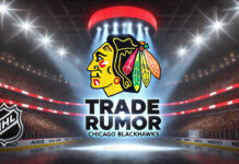 Chicago Blackhawks logo with the words trade rumor below the logo with the background of an NHL arena