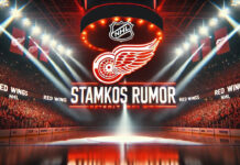Detroit Red Wings logo with the words Stamkos rumors below the logo with the background on an NHL arena