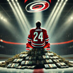 Seth Jarvis Inks Eight-Year Contract Extension with the Carolina Hurricanes Seth Jarvis sitting on stacks of money at center ice of the Carolina Hurricanes arena