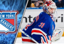 Igor Shesterkin in New York Rangers jersey, looking pensive during a game.