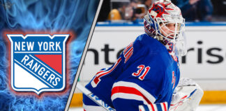Igor Shesterkin in New York Rangers jersey, looking pensive during a game.