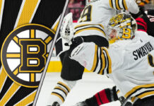 Jeremy Swayman, Boston Bruins goalie, stands tall in net during an NHL game.