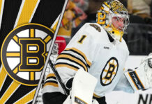 Jeremy Swayman in Boston Bruins uniform, looking determined during an NHL game