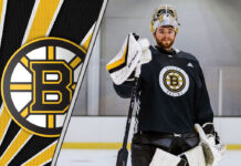 Jeremy Swayman in a Boston Bruins jersey looking concerned as contract negotiations stall.