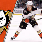 Trevor Zegras in an Anaheim Ducks jersey skating with the puck