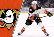 Trevor Zegras in an Anaheim Ducks jersey skating with the puck