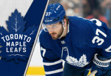 Toronto Maple Leafs defenseman Timothy Liljegren skating with the puck during an NHL game.