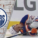 Darnell Nurse laying on the ice after a hit from Ryan Reaves