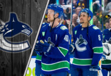 Elias Pettersson and J.T. Miller celebrate a Vancouver Canucks goal.