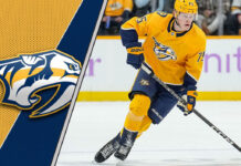 Juuso Parssinen skating with the puck during a Nashville Predators game.