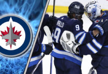 Winnipeg Jets players celebrating a victory on the ice.