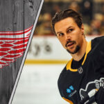 Erik Karlsson to Detroit? Yzerman’s Wild Card Play Could Change Everything! Erik Karlsson in a Pittsburgh Penguins jersey, with the Red Wings logo to the left, highlighting NHL trade rumors.