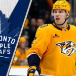 Luke Schenn Rumors: Maple Leafs Eye Reunion Amid Tanev Injury Crisis Luke Schenn in Nashville Predators jersey, with Maple Leafs logo overlay, indicating potential trade rumors.