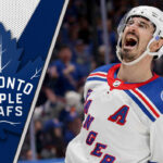 New York Rangers forward Chris Kreider skates with the puck, a potential trade target for the Toronto Maple Leafs.