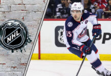 Dante Fabbro, right-shot defenseman, skating in his Columbus Blue Jackets jersey, amidst NHL trade rumors.