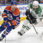 Dallas Stars and Edmonton Oilers players competing fiercely in Game 4 of the 2025 NHL Western Conference Finals.