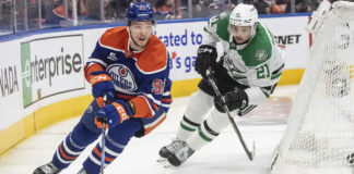 Dallas Stars and Edmonton Oilers players competing fiercely in Game 4 of the 2025 NHL Western Conference Finals.