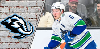 Brock Boeser in action, with the Utah Mammoth logo subtly in the background, representing NHL trade rumors.