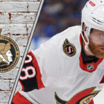 Ottawa Senators forward Claude Giroux skates with the puck, focused on the play, amidst ongoing contract extension discussions.