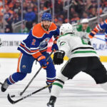 Dallas Stars and Edmonton Oilers players battling for the puck during the NHL Western Conference Finals Game 5.