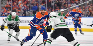 Dallas Stars and Edmonton Oilers players battling for the puck during the NHL Western Conference Finals Game 5.