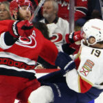 Florida Panthers and Carolina Hurricanes players in action during a playoff game.