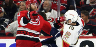 Florida Panthers and Carolina Hurricanes players in action during a playoff game.