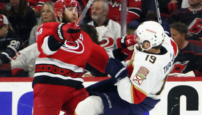 Florida Panthers and Carolina Hurricanes players in action during a playoff game.