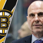 Rick Tocchet behind the bench during an NHL game, rumored to be a top coaching candidate for the Boston Bruins