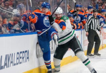 Edmonton Oilers and Dallas Stars logos clashing with a hockey puck, symbolizing their Game 2 playoff matchup on May 23 2025.