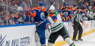 Edmonton Oilers and Dallas Stars logos clashing with a hockey puck, symbolizing their Game 2 playoff matchup on May 23 2025.