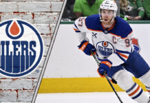 Edmonton Oilers captain Connor McDavid looks on thoughtfully during a game, contemplating his future contract extension.