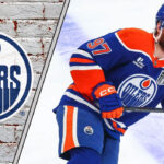 Edmonton Oilers captain Connor McDavid skates with the puck during an NHL game, focused and ready to make a play.