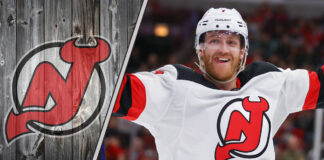 ew Jersey Devils defenseman Dougie Hamilton skates with the puck during an NHL game, with NHL trade rumors swirling around his future with the team.