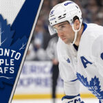 Toronto Maple Leafs forward John Tavares skates during a game, focused on the play, representing the latest Toronto Maple Leafs news.