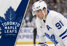 Toronto Maple Leafs forward John Tavares skates during a game, focused on the play, representing the latest Toronto Maple Leafs news.