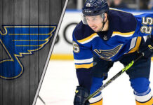 St. Louis Blues forward Jordan Kyrou skates with the puck during an NHL game, with NHL rumors intensifying.