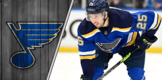 St. Louis Blues forward Jordan Kyrou skates with the puck during an NHL game, with NHL rumors intensifying.