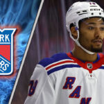 Decoding the K’Andre Miller Trade Buzz: Why the Rangers are Listening New York Rangers defenseman K'Andre Miller skates with the puck during an NHL game, with NHL trade rumors swirling.