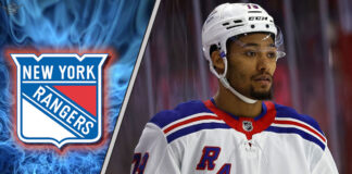 New York Rangers defenseman K'Andre Miller skates with the puck during an NHL game, with NHL trade rumors swirling.
