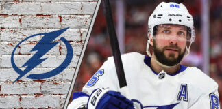 An intense, focused shot of Nikita Kucherov in his Tampa Bay Lightning jersey, stick in hand, looking ready to make a play on the ice.