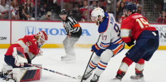 The Florida Panthers and Edmonton Oilers clash dramatically on the ice, symbolizing the intense battle for the Stanley Cup in Game 3.