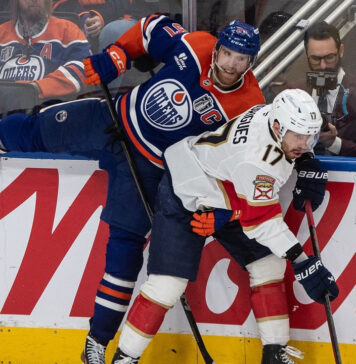 The Edmonton Oilers and Florida Panthers face off in a thrilling Stanley Cup Final Game 4 matchup, with players battling for the puck in front of the net.