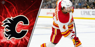 Calgary Flames defenseman Rasmus Andersson skates with the puck during an NHL game.